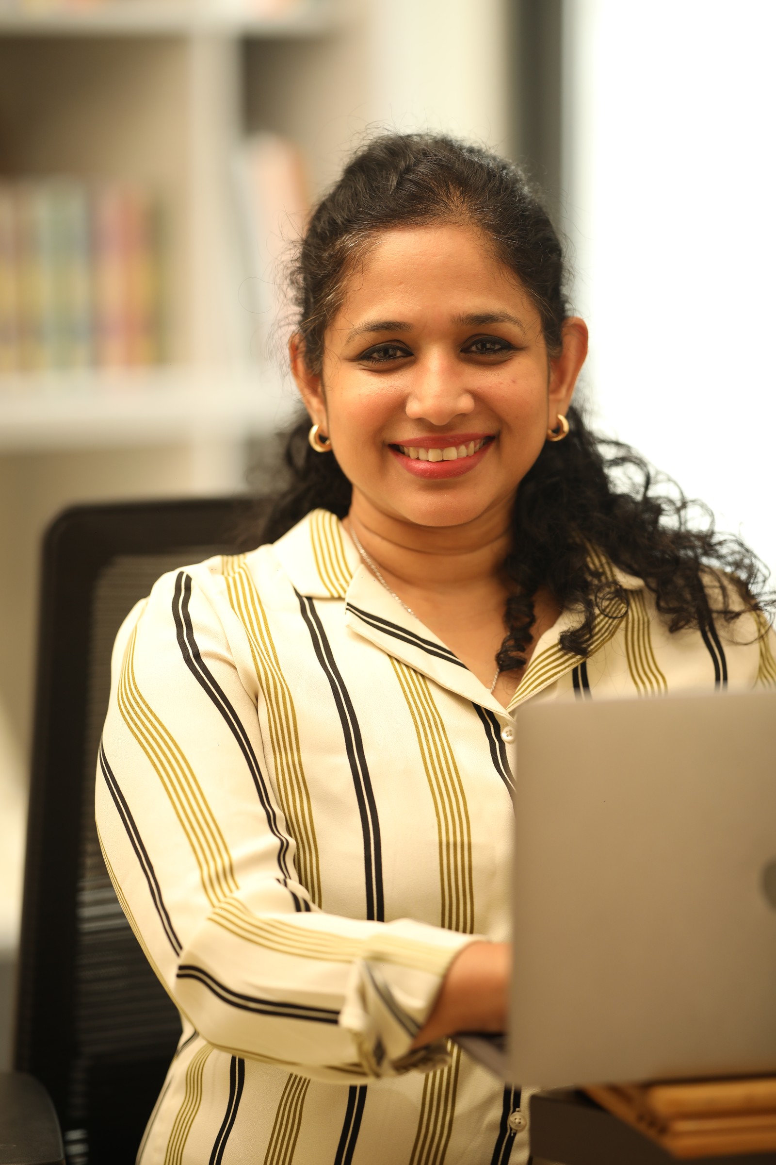 Shiny Surendran at her laptop for an online consultation